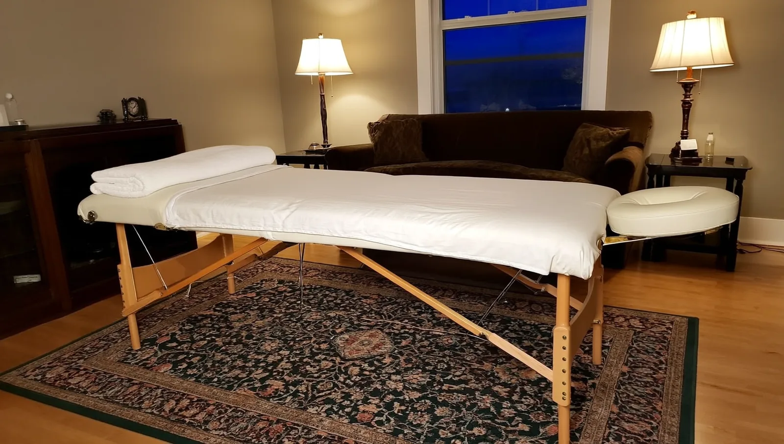 Portable massage table in a living room at night
