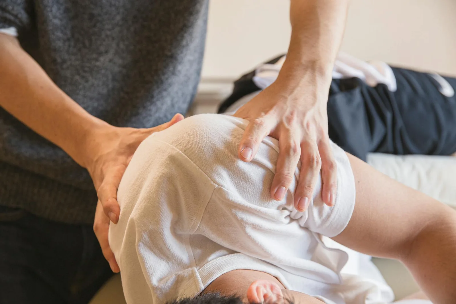 Therapist working on a client's shoulders to release stress-related tension.