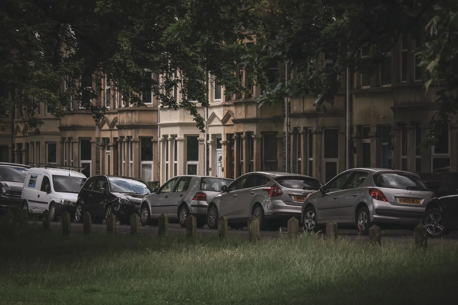 A row of cars parked along a residential street