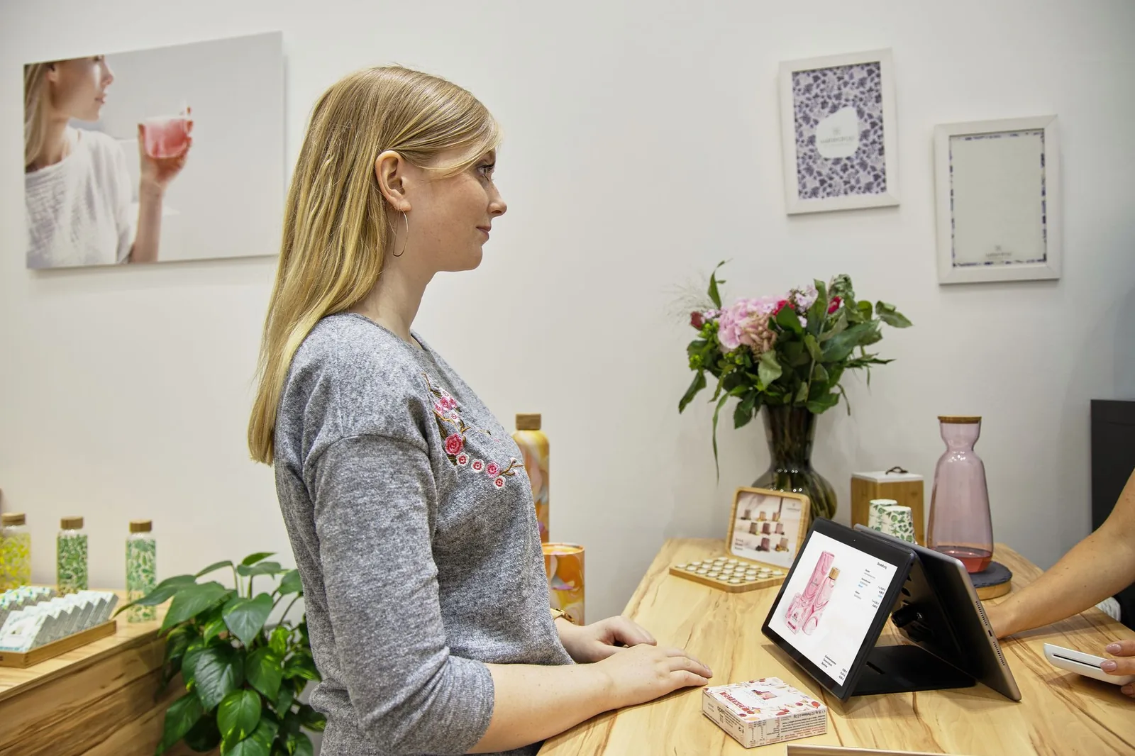 Woman at a spa reception desk with a staff member