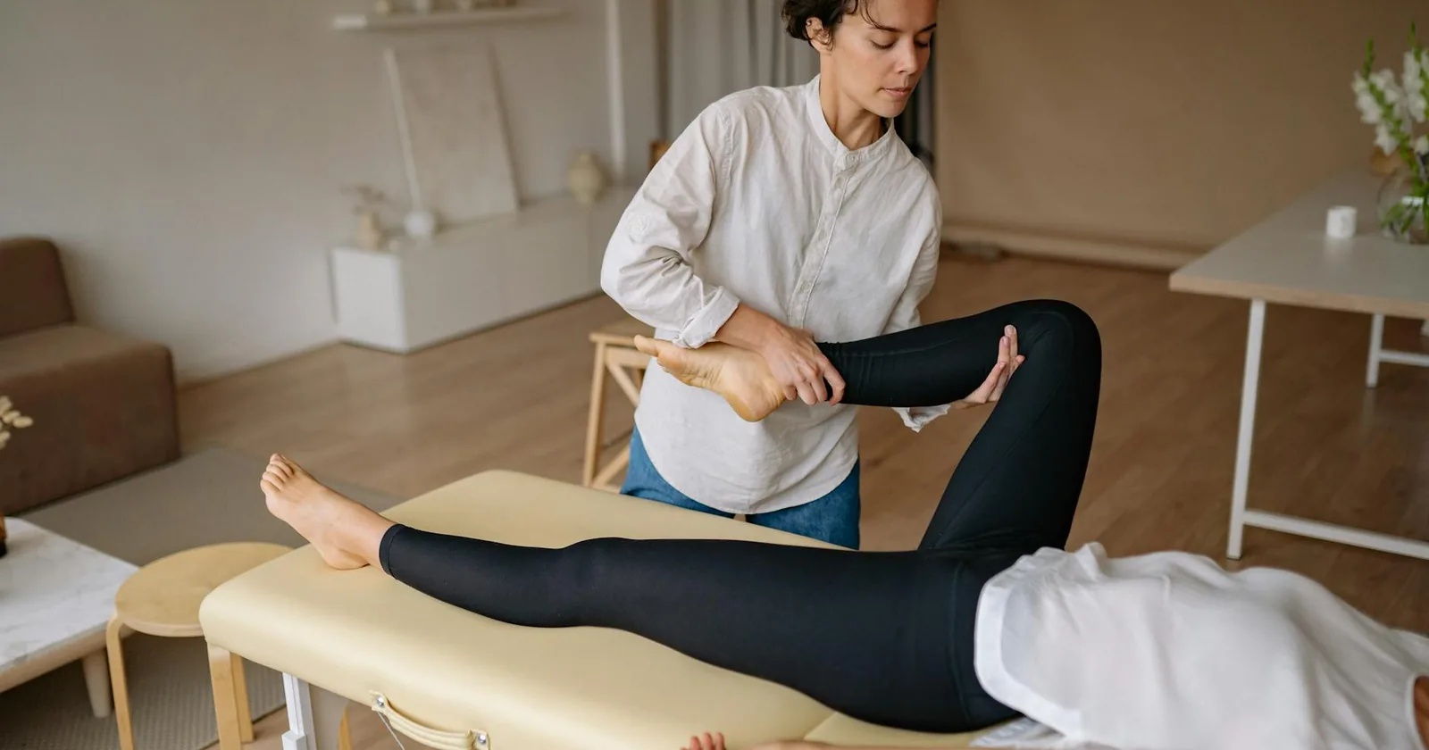 A mobile massage therapist working in a calm treatment setting, representing the professional standards a safety protocol is built on.